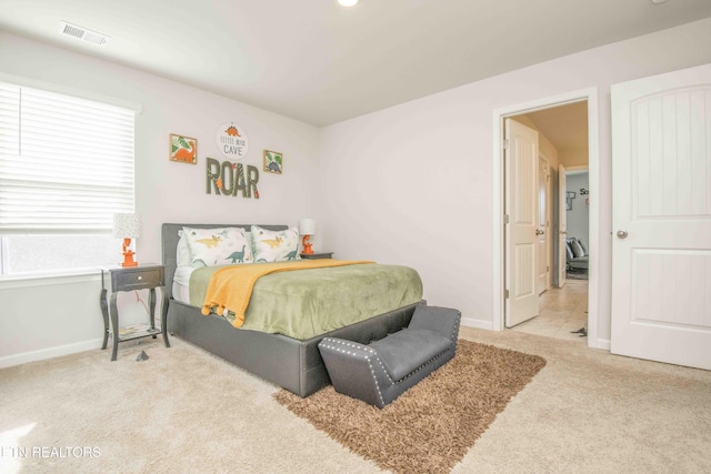 bedroom featuring baseboards, visible vents, and light colored carpet