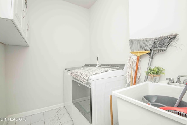 laundry room featuring marble finish floor, baseboards, a sink, and independent washer and dryer