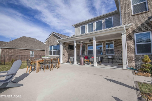 exterior space with ceiling fan, brick siding, a patio, and fence