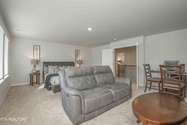 living room with visible vents, baseboards, and light colored carpet