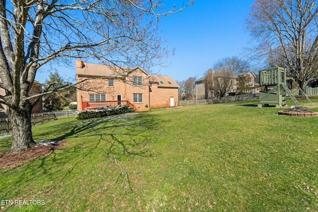 view of yard with a playground and a fenced backyard