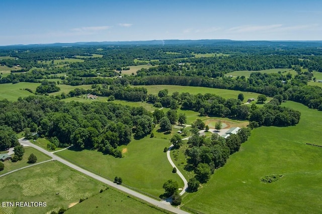 birds eye view of property featuring a forest view