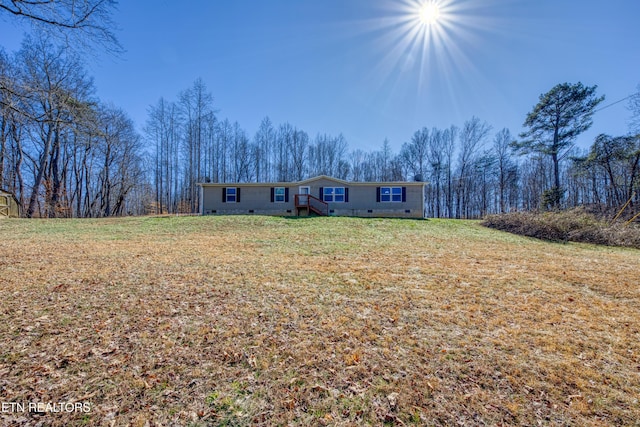 view of front facade with a front yard and crawl space