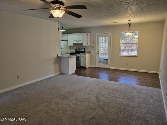 kitchen with dark carpet, freestanding refrigerator, stainless steel range with electric cooktop, white cabinetry, and under cabinet range hood