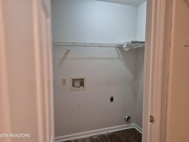 laundry area with a textured ceiling, hookup for an electric dryer, laundry area, washer hookup, and baseboards