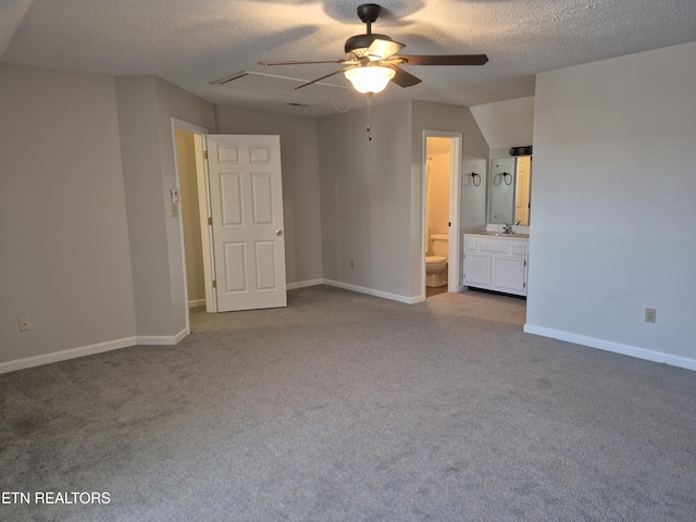 unfurnished bedroom featuring carpet, a sink, and baseboards