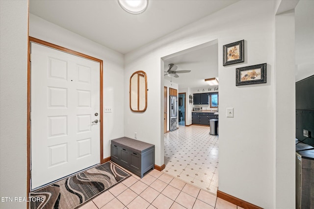 entryway featuring a ceiling fan and baseboards