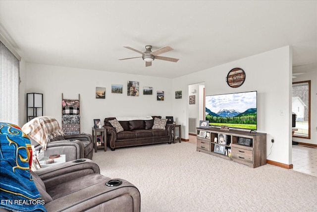 carpeted living room featuring visible vents, ceiling fan, and baseboards