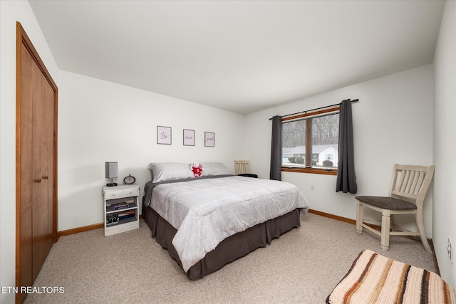 bedroom featuring light carpet and baseboards