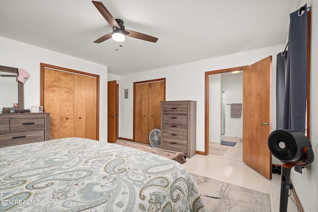 bedroom with ensuite bath, ceiling fan, and baseboards