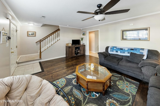 living area with visible vents, baseboards, stairs, ornamental molding, and wood finished floors