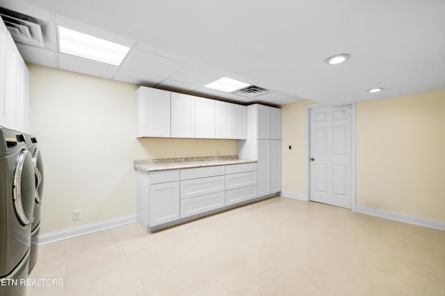 laundry room with baseboards, cabinet space, visible vents, and washer and dryer