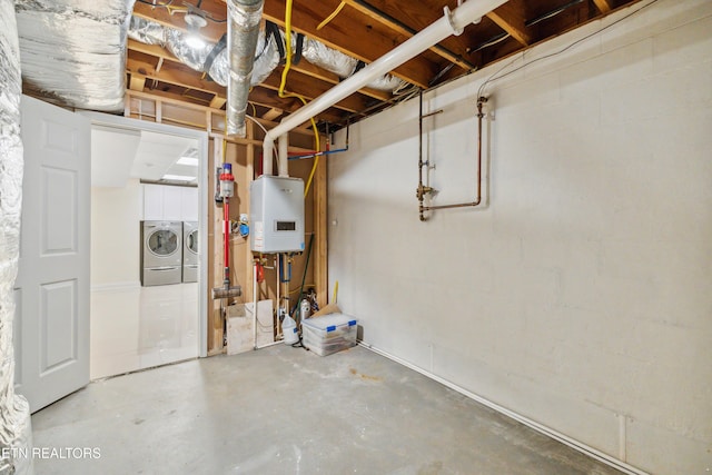 unfinished basement featuring tankless water heater and washer and clothes dryer