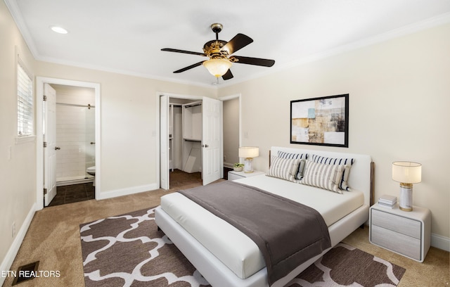 bedroom with ornamental molding, a closet, carpet, and baseboards