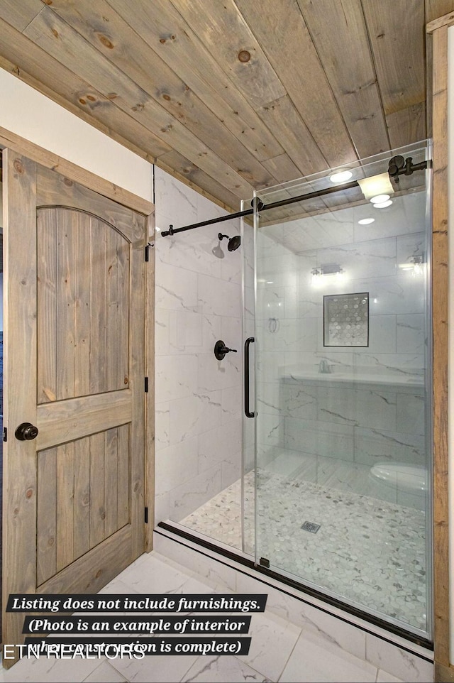 bathroom featuring wooden ceiling and a shower stall