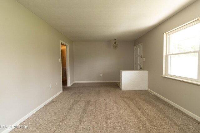 carpeted spare room with baseboards