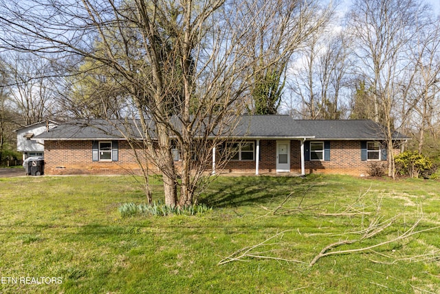 single story home featuring brick siding and a front lawn