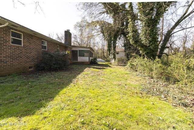 view of yard featuring a sunroom