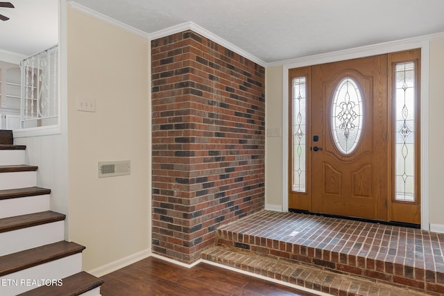 foyer with stairs, ornamental molding, dark wood-type flooring, and baseboards