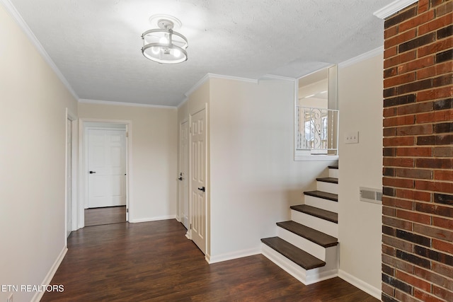 hall featuring a textured ceiling, dark wood-type flooring, and ornamental molding