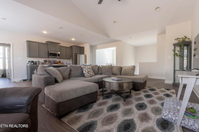 living area featuring dark wood-style floors, recessed lighting, high vaulted ceiling, and baseboards