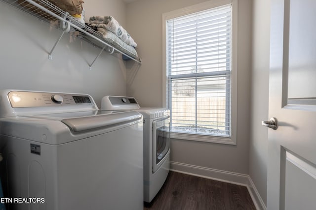 laundry area featuring laundry area, baseboards, dark wood-style floors, and washing machine and clothes dryer