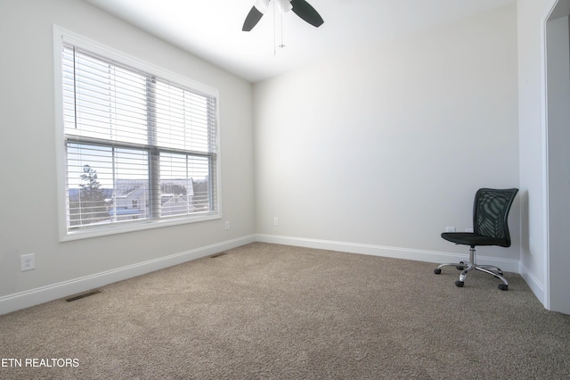 spare room featuring carpet floors, visible vents, ceiling fan, and baseboards