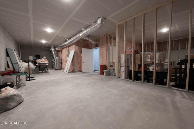 unfinished basement featuring water heater