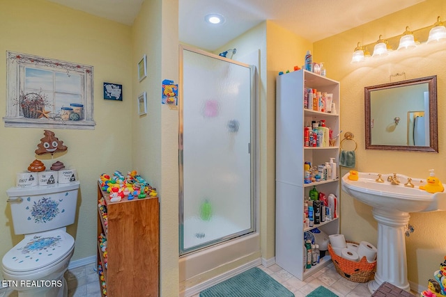 full bathroom with toilet, baseboards, a sink, and tile patterned floors