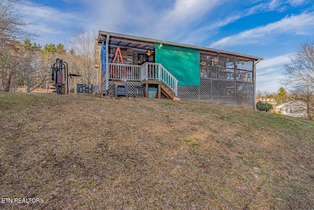 exterior space featuring a front lawn and a sunroom