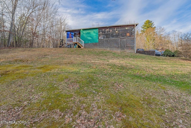 exterior space featuring a sunroom and a yard