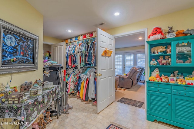 walk in closet with light floors and visible vents