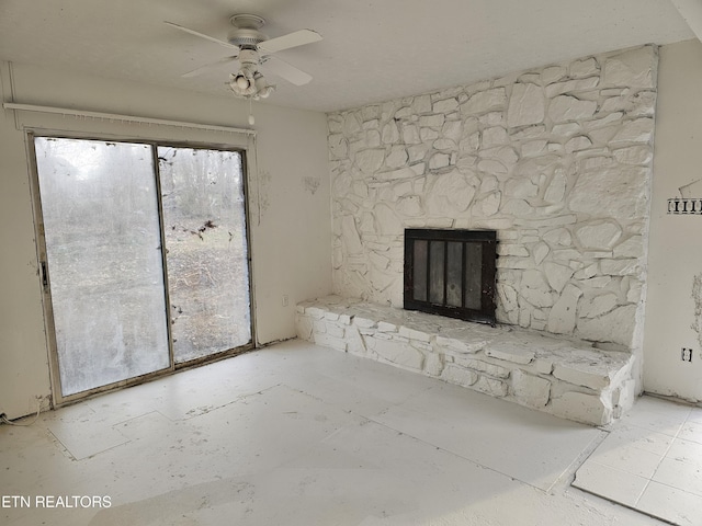 unfurnished living room with a ceiling fan and a fireplace