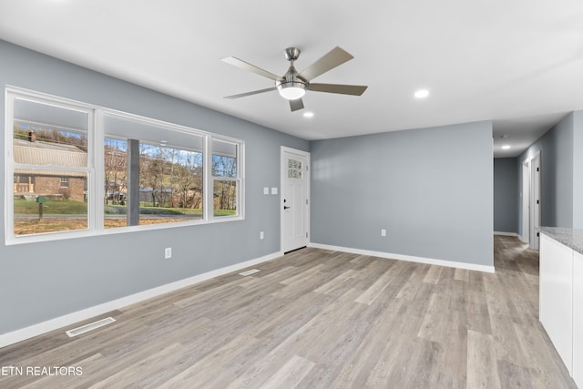 unfurnished room featuring light wood finished floors, baseboards, visible vents, a ceiling fan, and recessed lighting