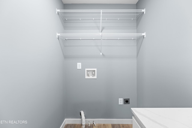 washroom featuring laundry area, baseboards, wood finished floors, hookup for a washing machine, and hookup for an electric dryer