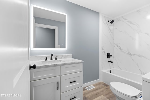 bathroom featuring shower / tub combination, toilet, wood finished floors, visible vents, and vanity