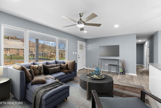 living room featuring a ceiling fan, recessed lighting, baseboards, and wood finished floors