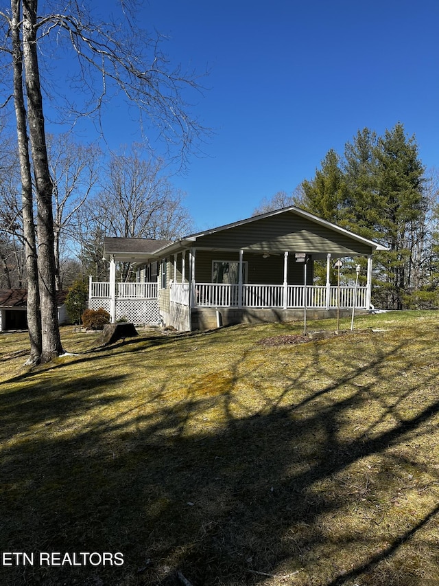 view of front facade featuring covered porch and a front yard