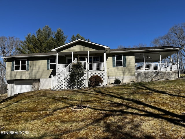 single story home featuring covered porch, ceiling fan, a front lawn, and an attached garage