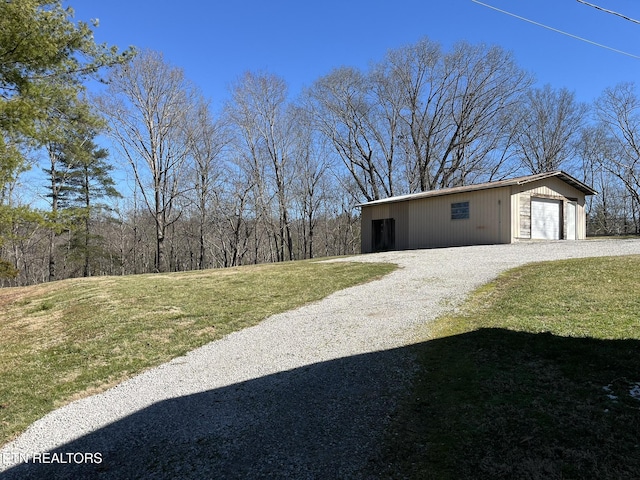 view of yard with a garage and an outdoor structure