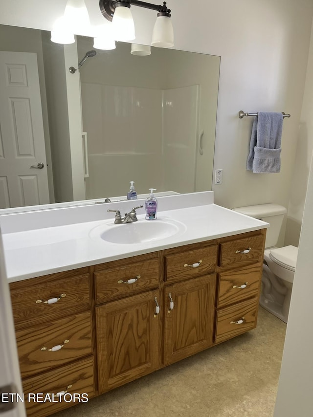 full bathroom with vanity and toilet