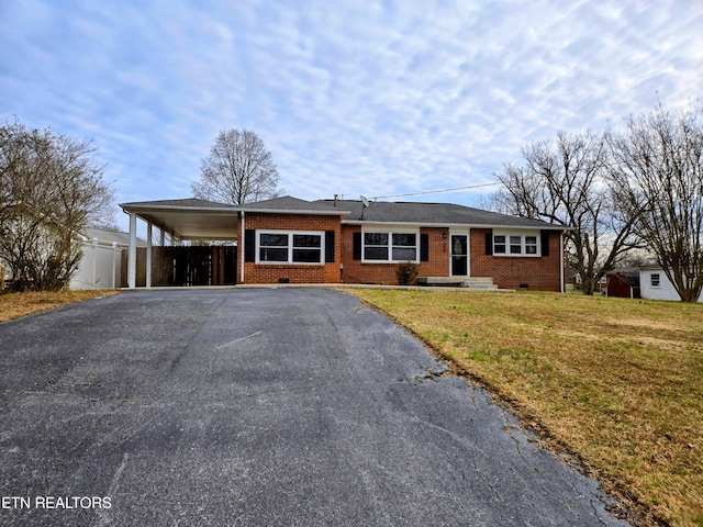 single story home featuring driveway, an attached carport, crawl space, a front yard, and brick siding