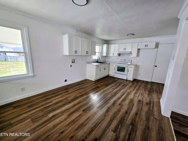 kitchen featuring electric stove, dark wood finished floors, light countertops, white cabinetry, and a sink