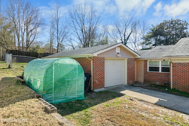 exterior space with a garage, driveway, and fence