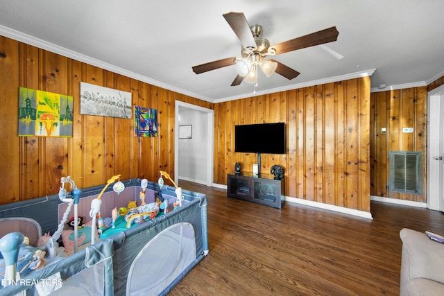 interior space with baseboards, visible vents, dark wood-style floors, ceiling fan, and ornamental molding