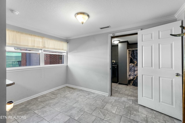 empty room featuring a textured ceiling, baseboards, visible vents, and crown molding