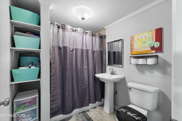 bathroom with a sink, crown molding, a textured ceiling, and toilet