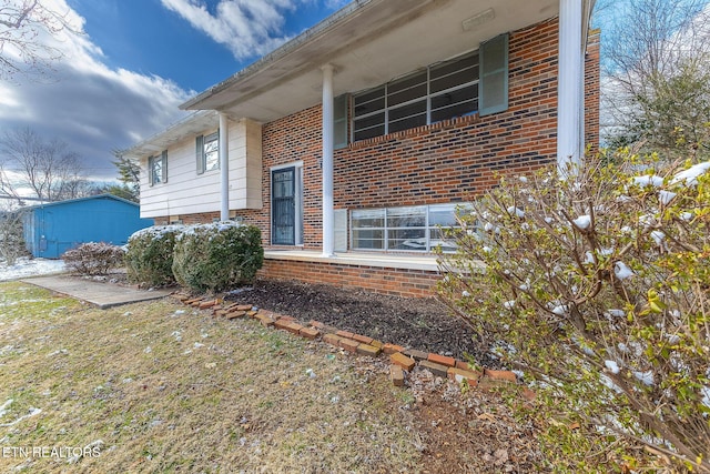 view of exterior entry with brick siding