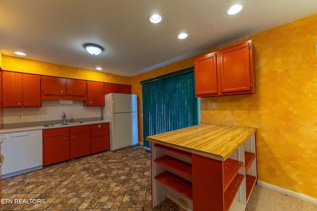 kitchen featuring white appliances, baseboards, a sink, open shelves, and backsplash