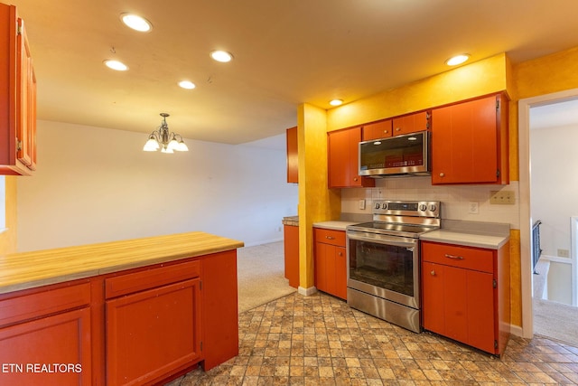 kitchen with decorative light fixtures, tasteful backsplash, recessed lighting, light countertops, and appliances with stainless steel finishes